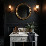 Dramatic moody half bathroom with dark walls and brass fixtures