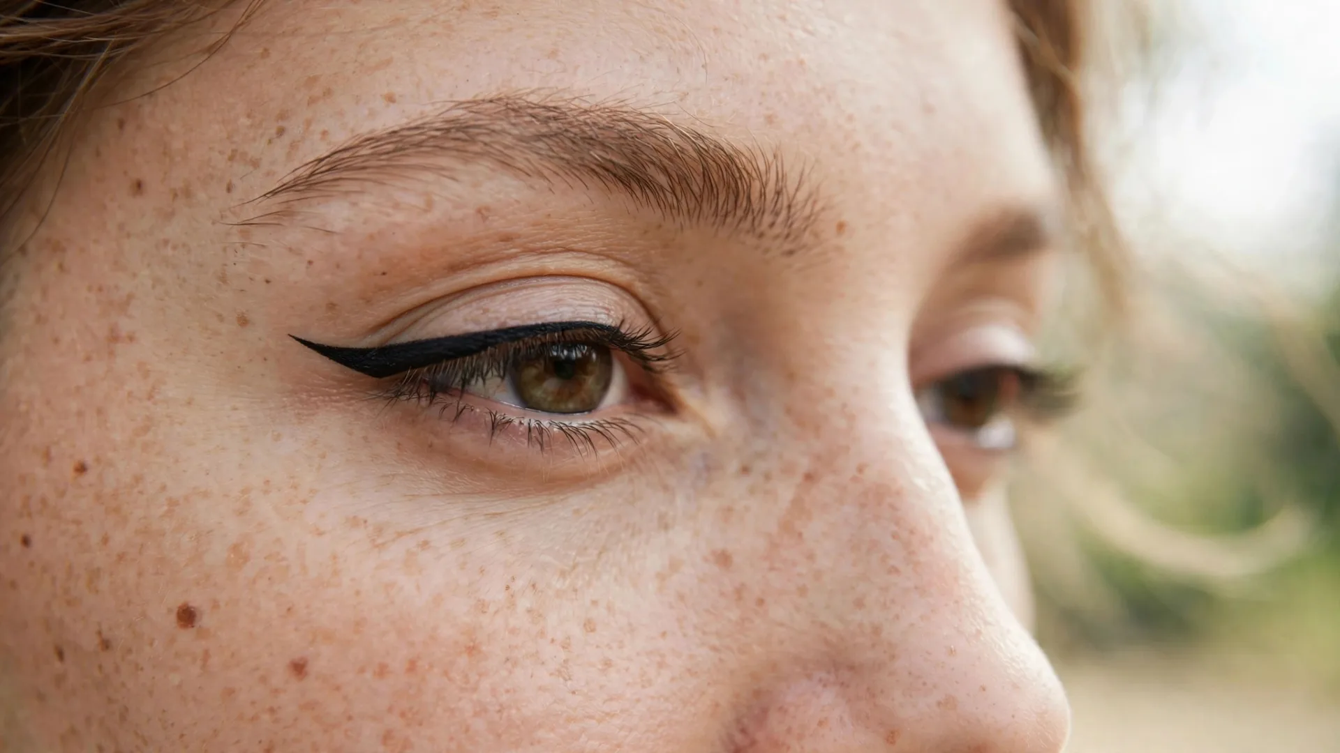 Close-up of a woman with hooded eyes wearing a sharp everyday winged eyeliner