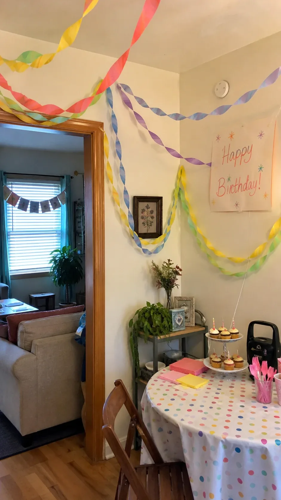 Crepe paper streamers draped across a ceiling in curves for a birthday party